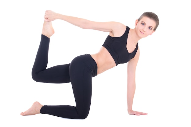 Young beautiful sporty woman doing stretching exercises isolated on white background