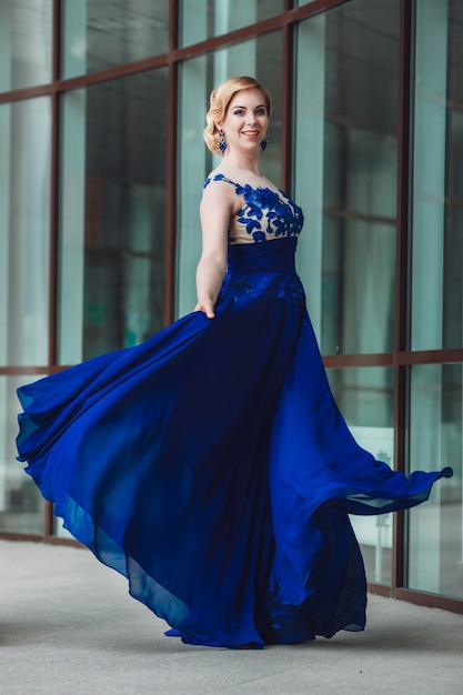 Young beautiful stylish girl walking and posing in city. Outdoor summer portrait of young classy woman