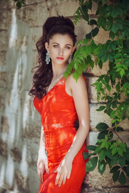 Young beautiful stylish girl walking and posing in city. Outdoor summer portrait of young classy woman