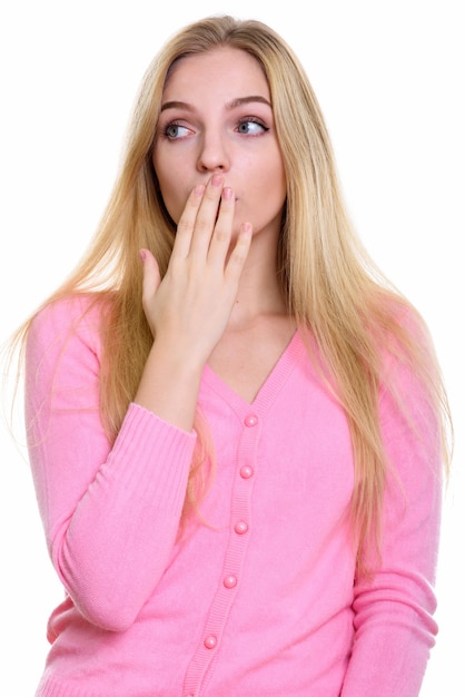 young beautiful teenage girl covering mouth while