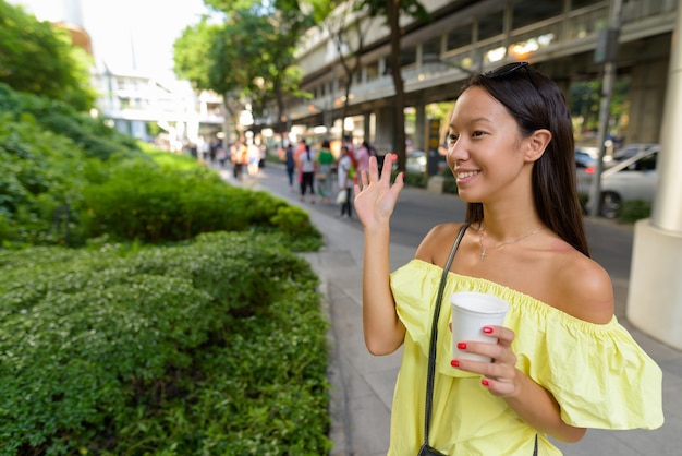 Young beautiful tourist woman exploring the city of Bangkok