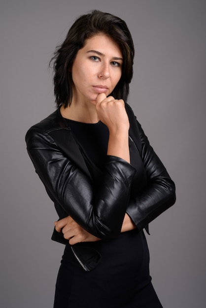 Young beautiful woman against gray background