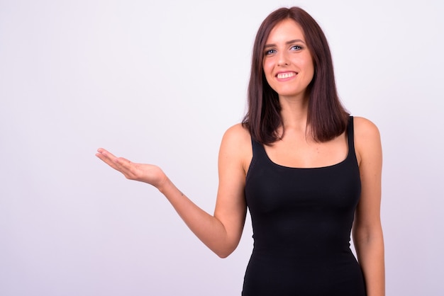 Young beautiful woman against white wall