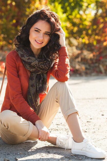 Young beautiful woman at autumn . Portrait of attractive young girl outdoors