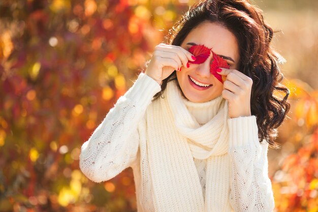 Young beautiful woman at autumn . Portrait of attractive young girl outdoors