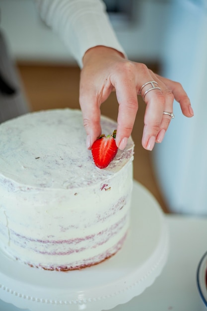 Young beautiful woman bakes a cake. Sweets. Confectionery.