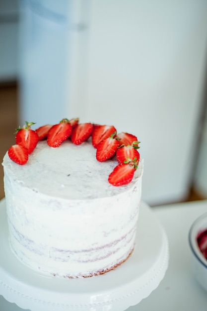 Young beautiful woman bakes a cake. Sweets. Confectionery.