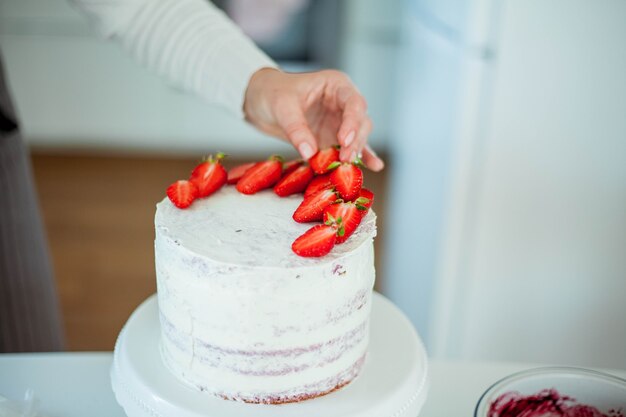 Young beautiful woman bakes a cake. Sweets. Confectionery.