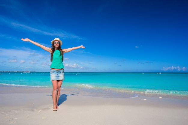 Young beautiful woman on beach during her summer vacation