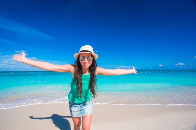 Young beautiful woman on beach during tropical vacation