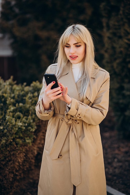 Young beautiful woman in beige coat