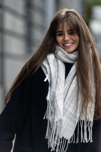 A young beautiful woman in a black coat