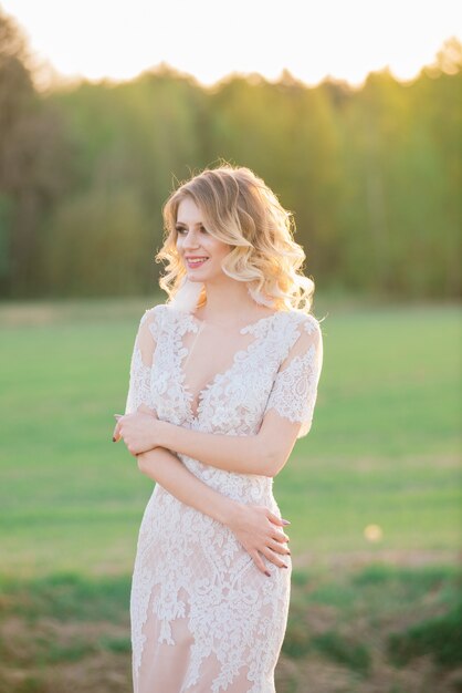 Young beautiful woman in blooming garden. Bride.