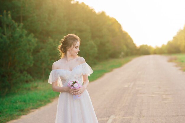 Young beautiful woman in blooming garden