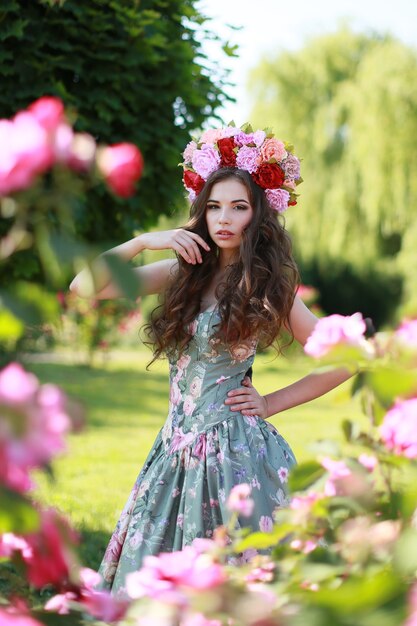 Young beautiful woman in blooming garden