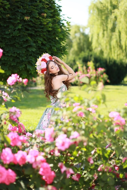 Young beautiful woman in blooming garden