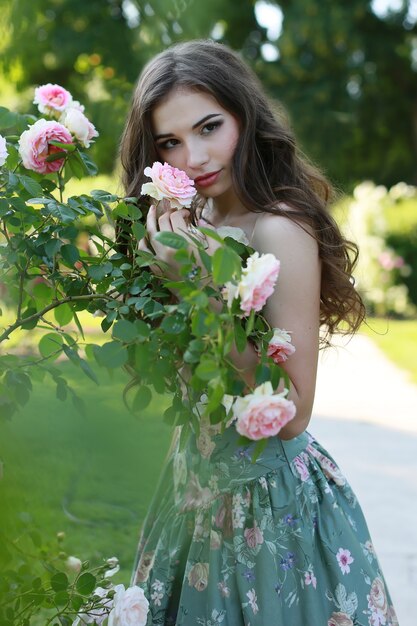 Young beautiful woman in blooming garden