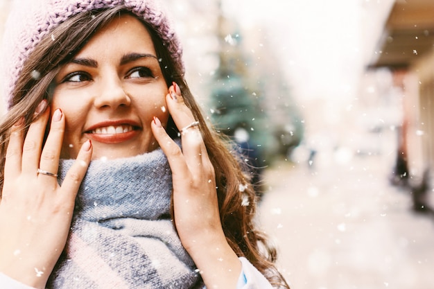 Young beautiful woman in coat and hat in late autumn or winter o