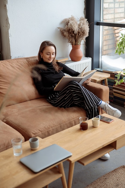 Young beautiful woman in cozy modern cafe