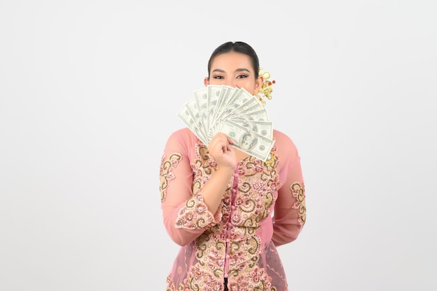 Young beautiful woman dress up in local culture in southern region pose with banknote