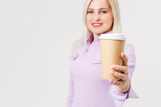 Young beautiful woman drinking paper glass of coffee over isolated white background