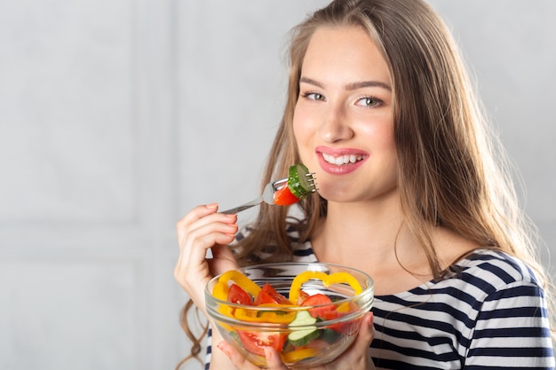 Young beautiful woman eating healthy food 