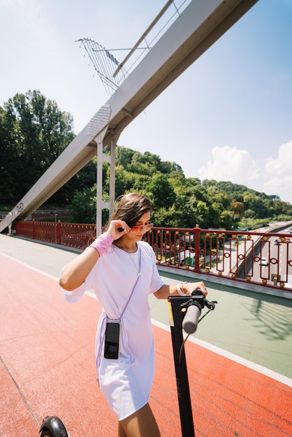 Young beautiful woman and an electric scooter