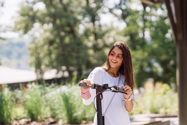 Young beautiful woman and an electric scooter