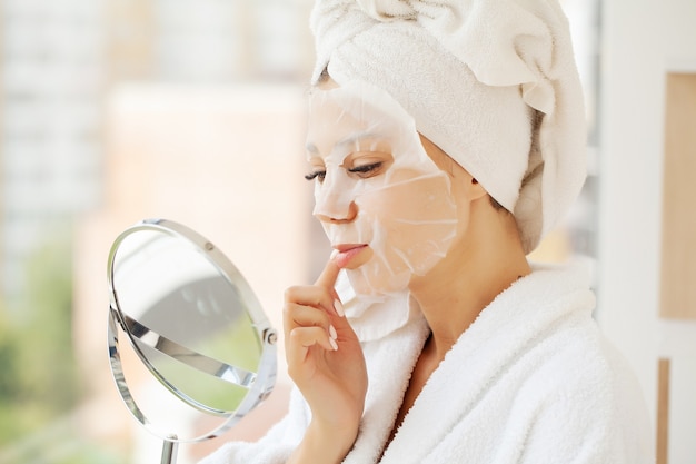 Young beautiful woman in a face mask, skin care.