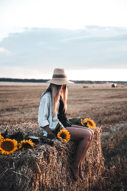 Young beautiful woman on field in summer