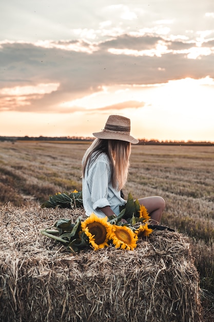 Young beautiful woman on field in summer