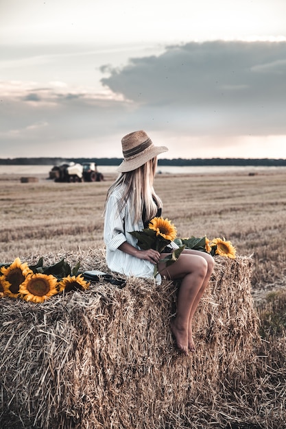 Young beautiful woman on field in summer