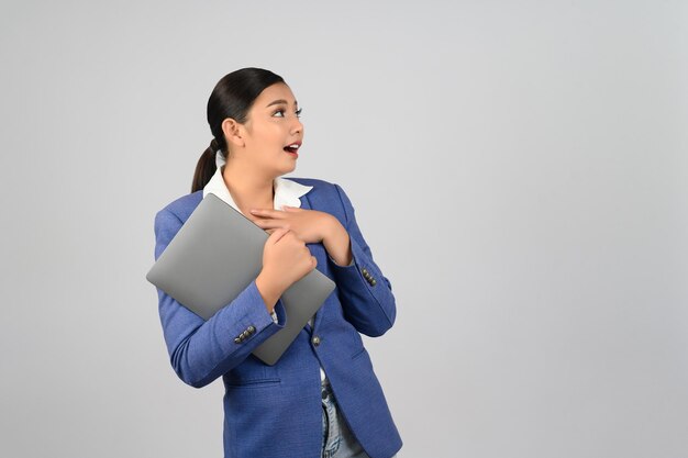 Young beautiful woman in formal clothing for officer holding laptop computer