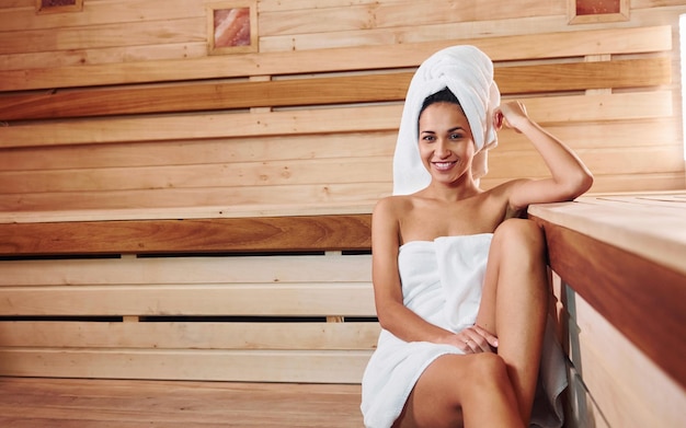 Young beautiful woman have a rest in the sauna. Conception of bodycare.