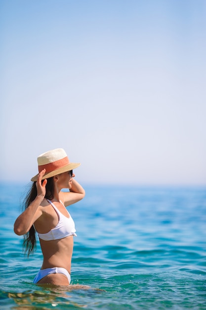 Young beautiful woman having fun on tropical seashore