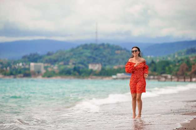 Young beautiful woman having fun on tropical seashore