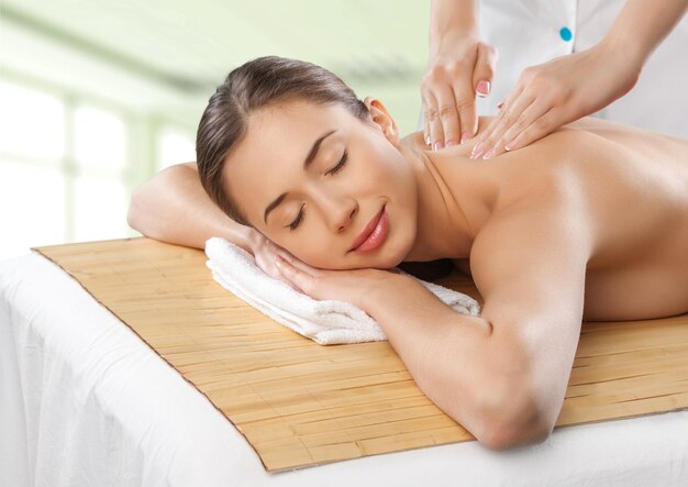 Young beautiful woman having treatment in spa salon