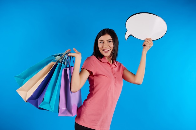 Young beautiful woman holding paper bags.