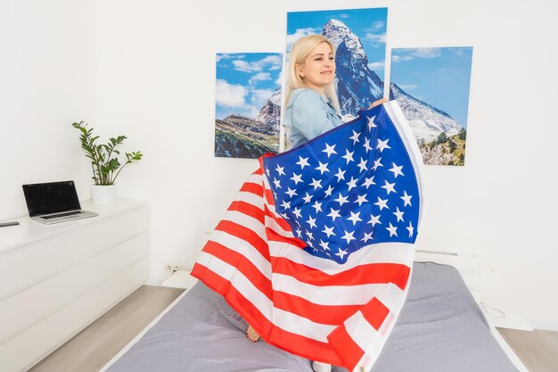 young beautiful woman holding USA flag.