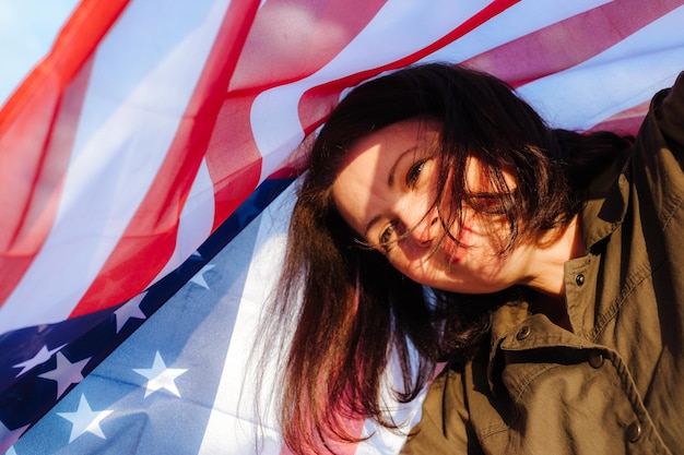 Young beautiful woman holding USA flag