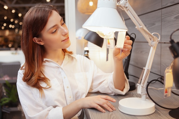 Young beautiful woman in a home goods store