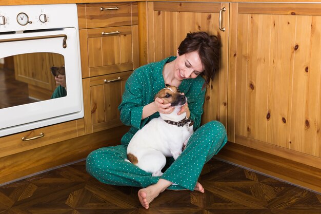 Young beautiful woman at home with her cute dog