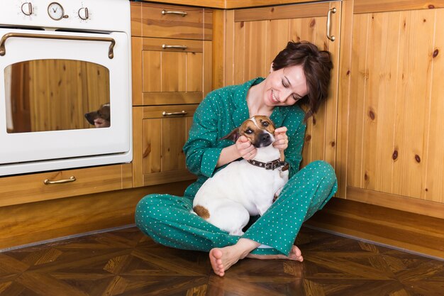 Young beautiful woman at home with her cute dog