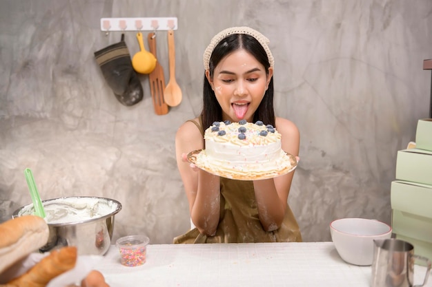 Young beautiful woman is baking in her kitchen bakery and coffee shop business