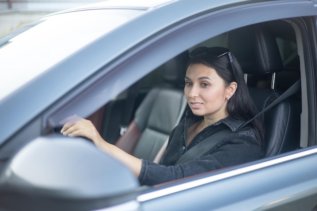 A young beautiful woman is the driver in her car in town Commute commute Lifestyle