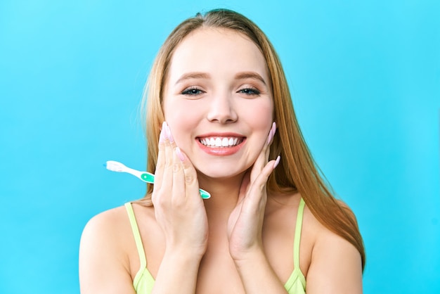 Young beautiful woman is engaged in cleaning teeth