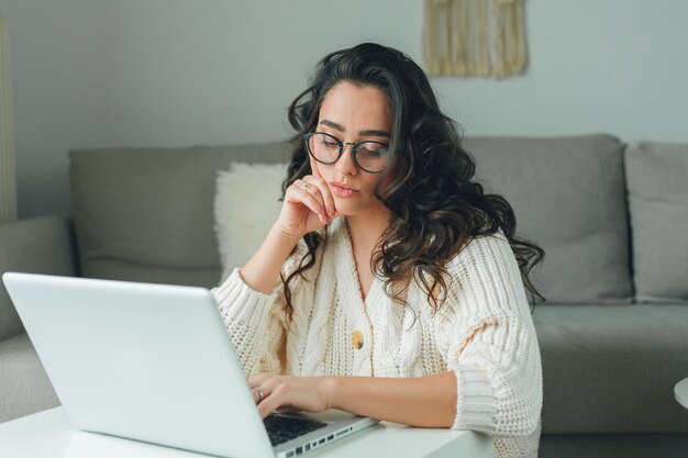 Young beautiful woman is shopping online. Working on the Internet. Home Office. Covid19.