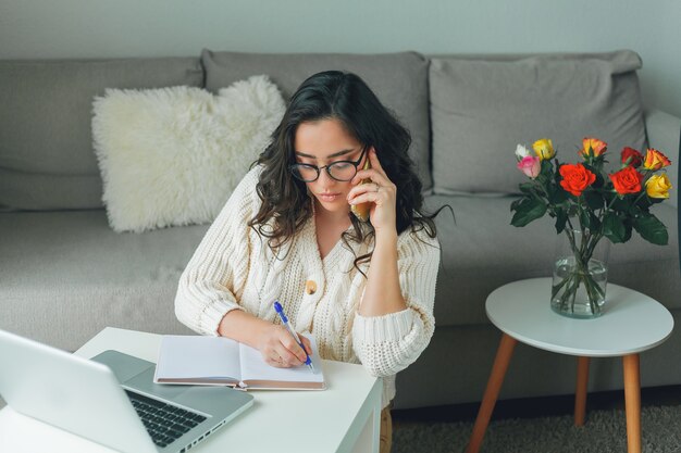 Young beautiful woman is shopping online. Working on the Internet. Home Office. Covid19.