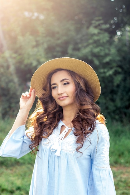 Young beautiful woman is walking in the park. Summer. A girl is walking in the spring. Field. Warm.