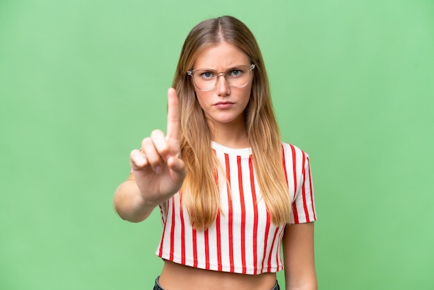 Young beautiful woman over isolated background counting one with serious expression